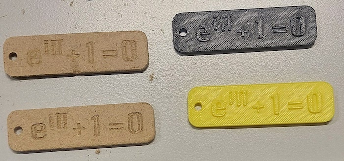Four Key holders, 2 were 3D printed and two were CNC milled. In the latter objects, the equation was engraved, while the printed objects have the equation standing out.